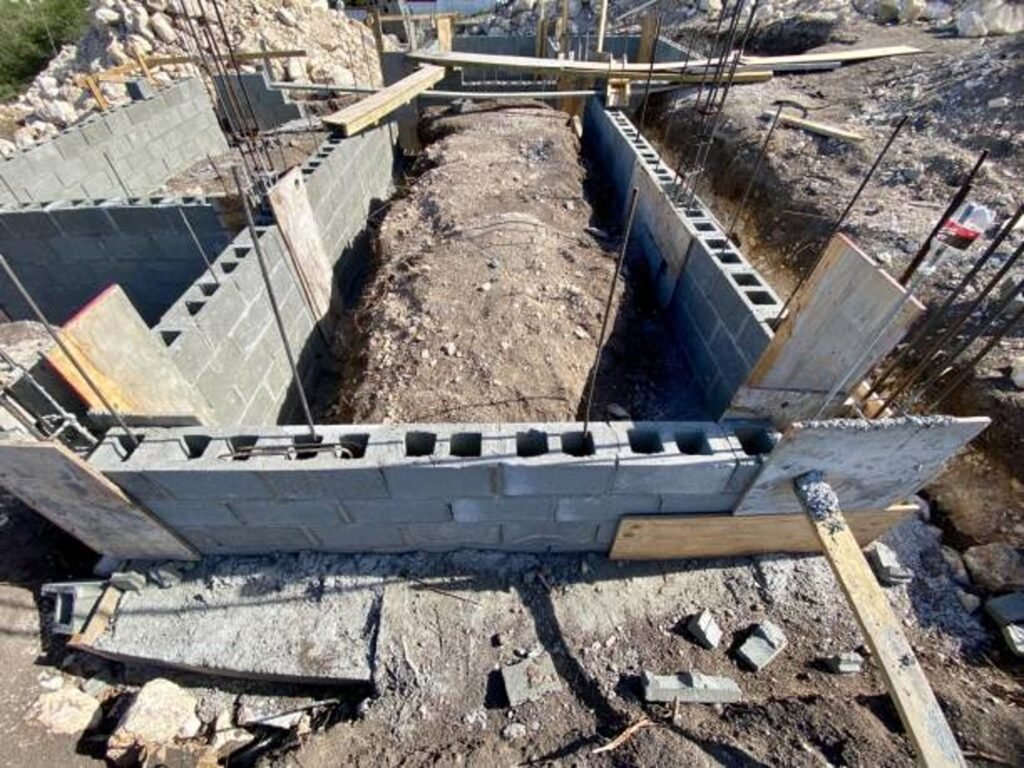 Concrete foundation installation with block walls and framing setup on construction site in Strongsville, OH