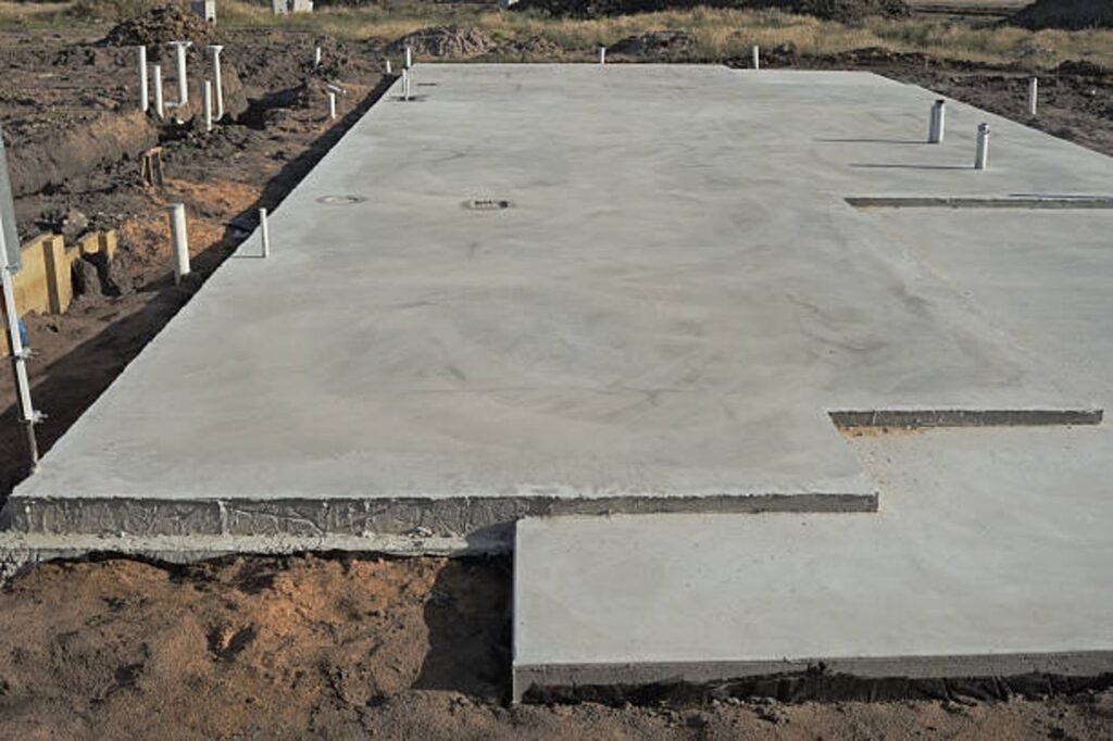 Newly poured concrete slab foundation with smooth finish and structural layout in Strongsville, OH