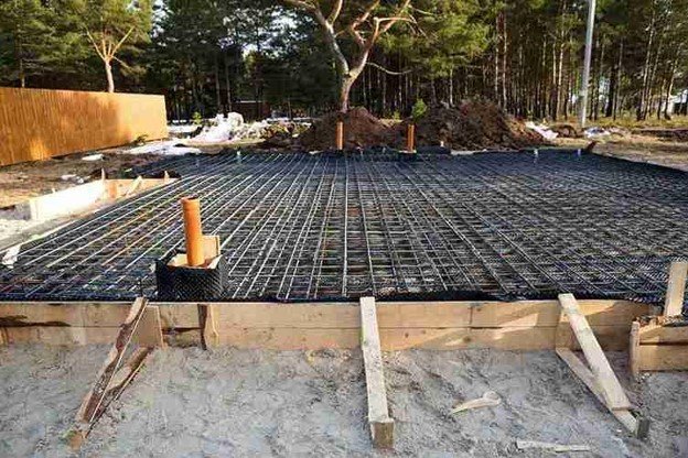 Concrete slab preparation with steel rebar reinforcement grid before pouring foundation in Strongsville, OH